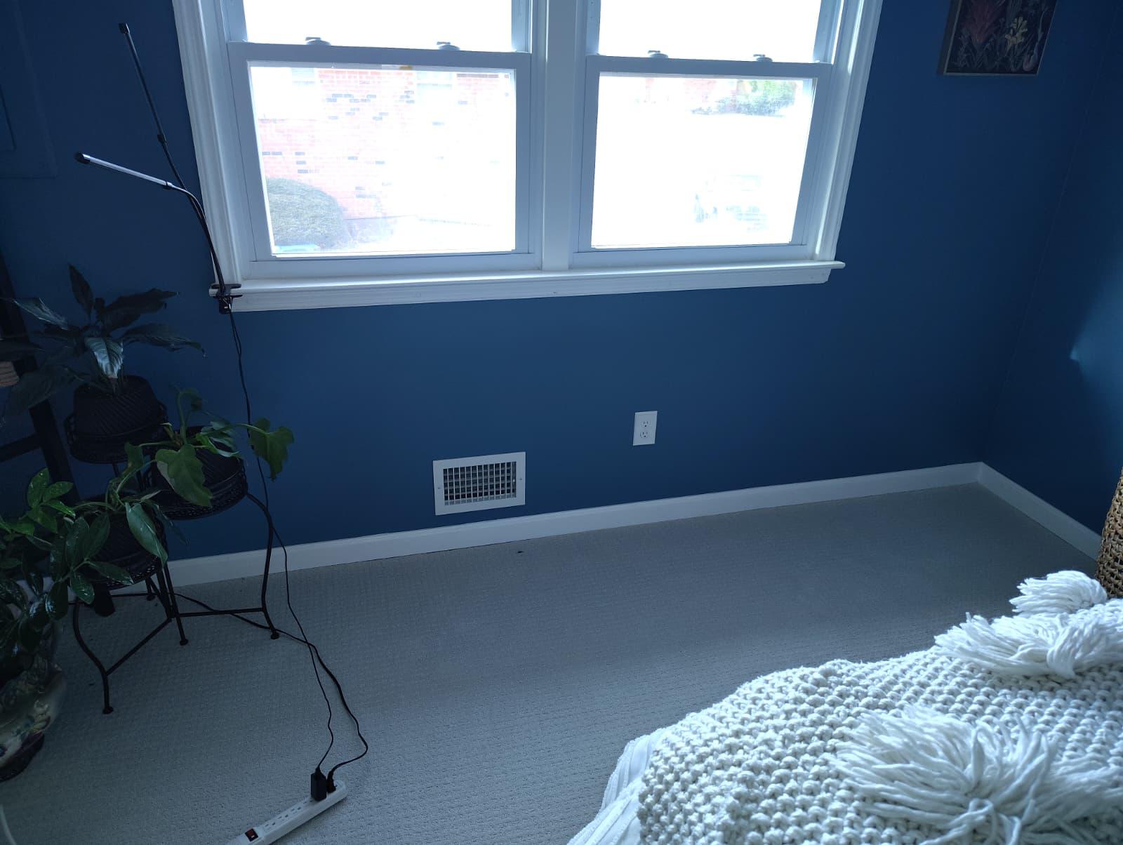 Finished wall after drywall replacement, repaint and new baseboard trim