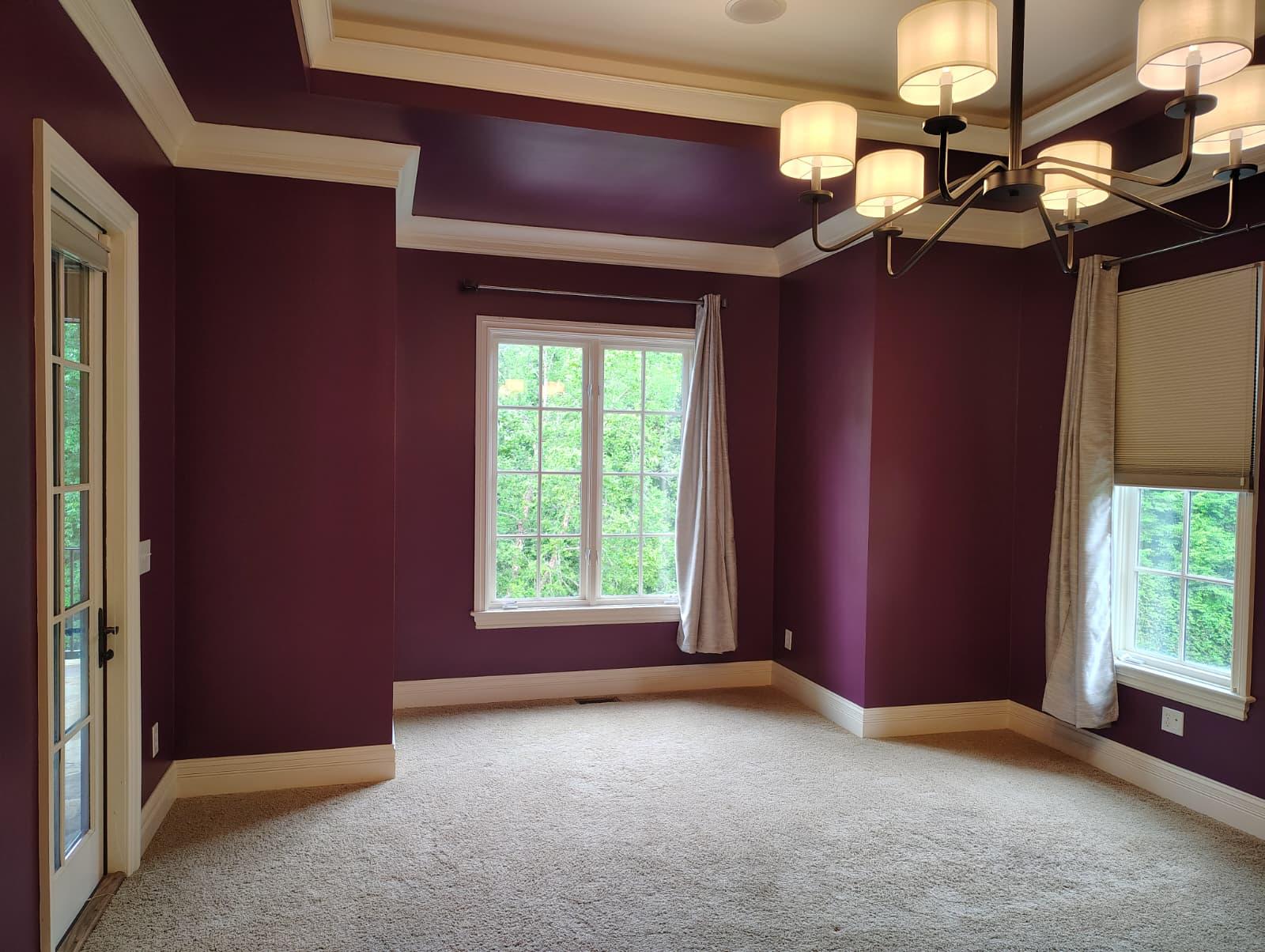 Freshly painted burgundy dining room with white crown molding