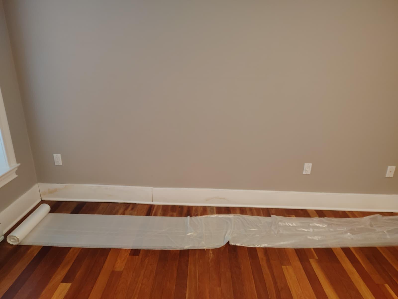 Finished room with new painted baseboards and clean hardwood floor